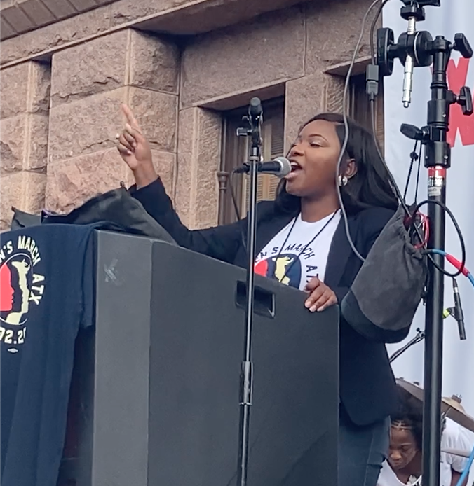 State Sen. Jasmine Crockett speaks to protesters on the south lawn of the Texas State Capitol on October 2 during Women's March ATX.