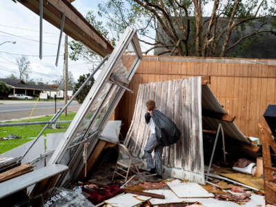 Chelsea Jenkins salvages whatever she can from the Be Love hair salon, owned by Jenkins's mother, which was destroyed by Hurricane Ida on August 30, 2021, in LaPlace, Louisiana.