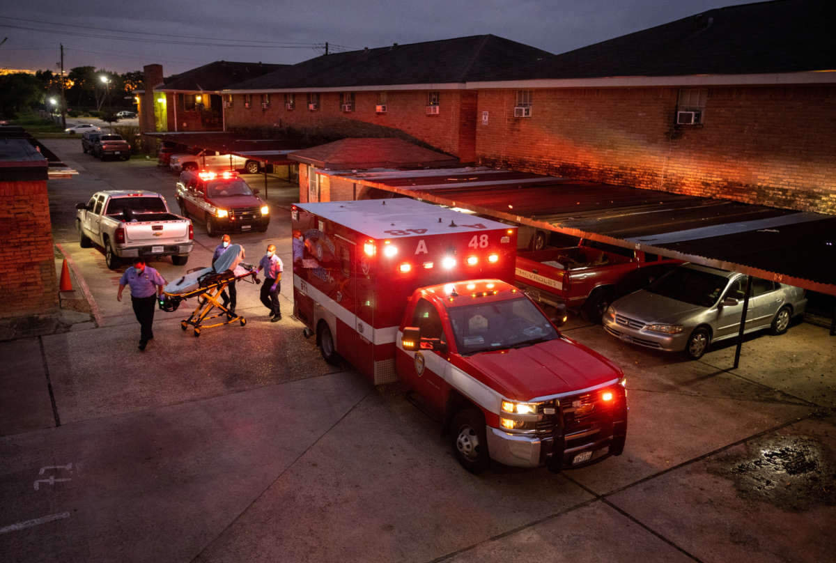 Houston Fire Department paramedics prepare to transport a COVID-19 positive woman to a hospital on September 15, 2021, in Houston, Texas.