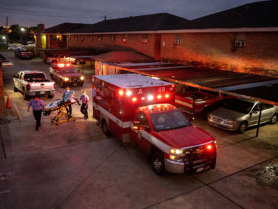 Houston Fire Department paramedics prepare to transport a COVID-19 positive woman to a hospital on September 15, 2021, in Houston, Texas.