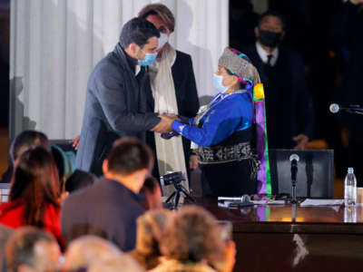 Constitutional lawyer Jaime Bassa, left, elected vice president of the Constitutional Convention, is greeted by elected President Elisa Loncón at the National Congress during the First Constituent Assembly in Santiago, Chile, on July 4, 2021.