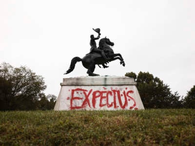 The words "Expect Us" are seen painted at the base of a statue of U.S. President Andrew Jackson during a climate march in honor of Indigenous Peoples’ Day at in front of the White House on October 11, 2021 in Washington, D.C.