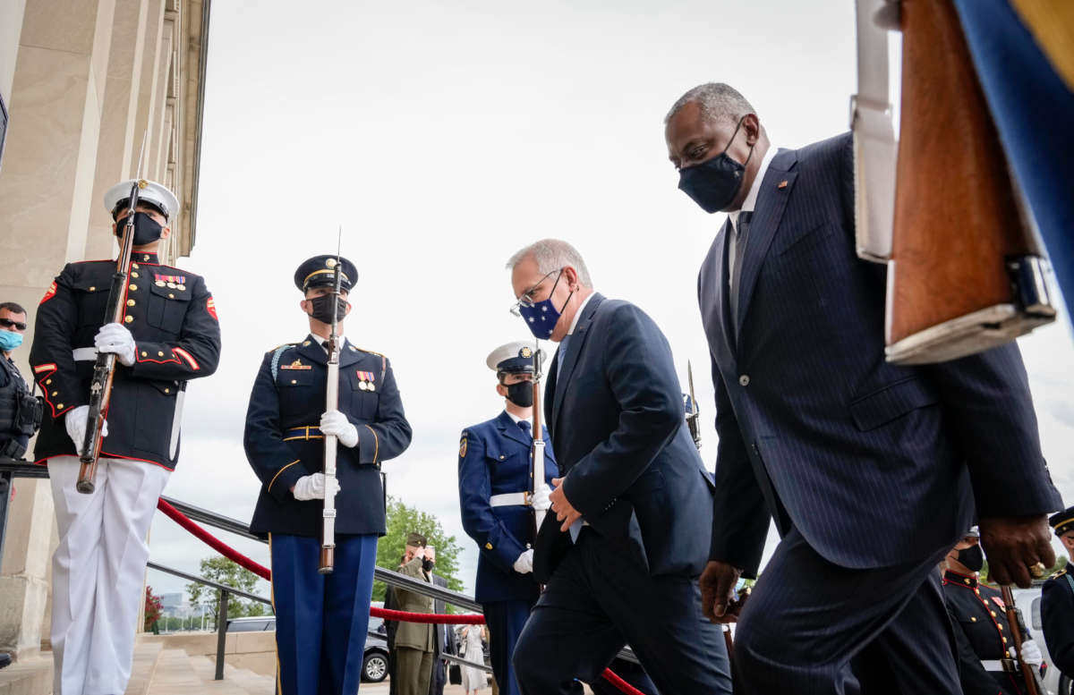 Prime Minister of Australia Scott Morrison and U.S. Secretary of Defense Lloyd Austin walk past a military honor guard as they walk inside for a meeting at the Pentagon on September 22, 2021, in Arlington, Virginia.