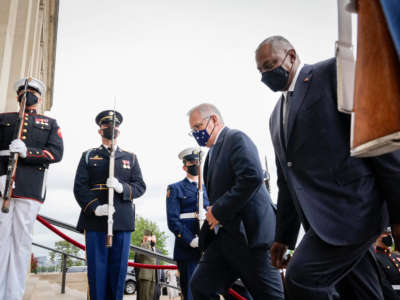 Prime Minister of Australia Scott Morrison and U.S. Secretary of Defense Lloyd Austin walk past a military honor guard as they walk inside for a meeting at the Pentagon on September 22, 2021, in Arlington, Virginia.