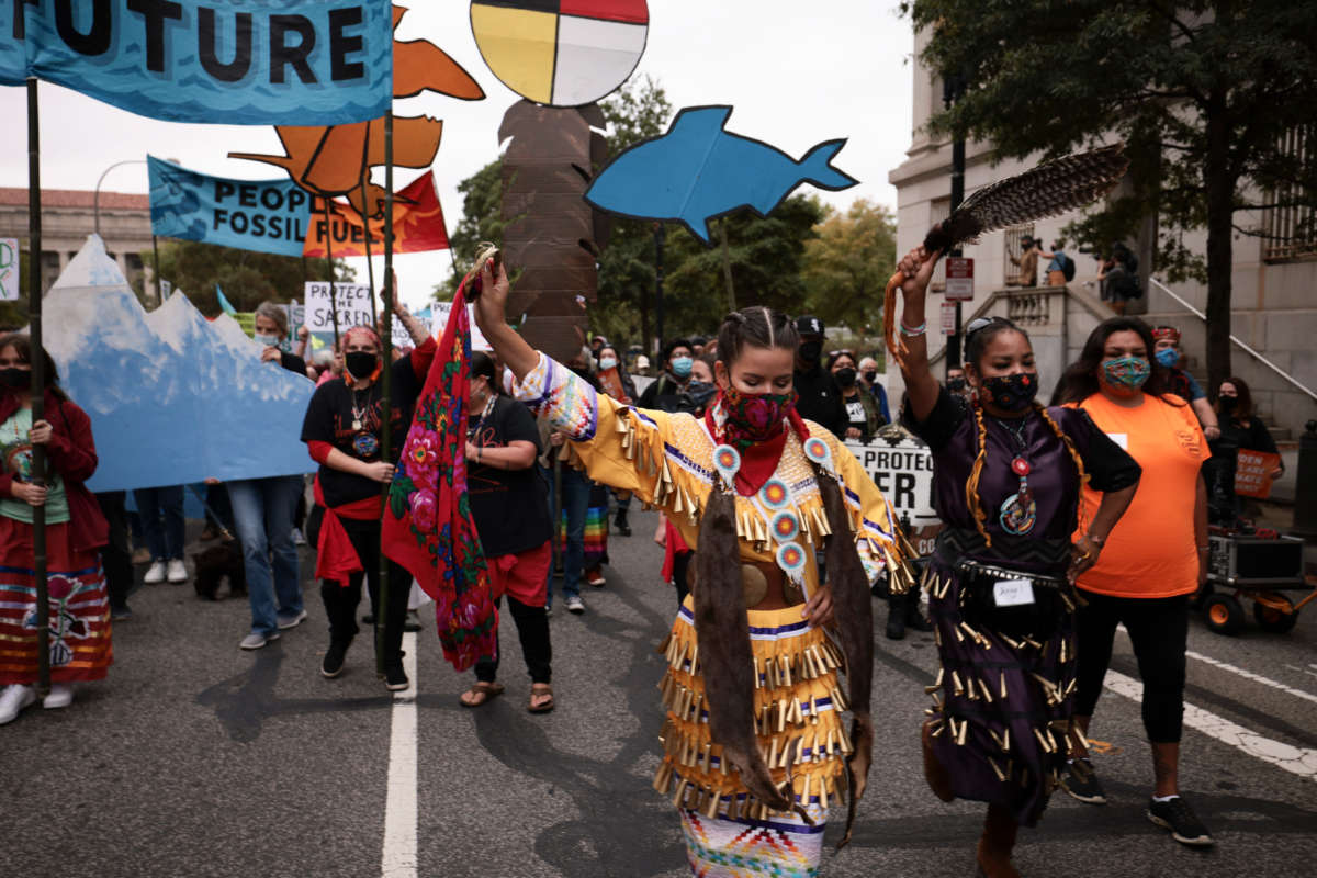 Demonstrators dance as they march in honor of Indigenous Peoples’ Day at Freedom Plaza on October 11, 2021, in Washington, D.C.