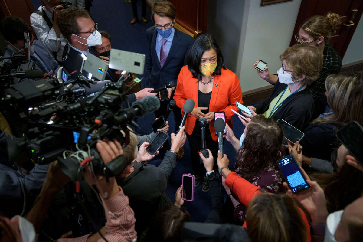 Rep. Pramila Jayapal speaks to journalists surrounding her