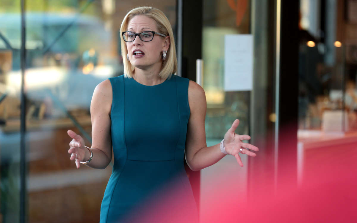 Congresswoman Kyrsten Sinema speaking with supporters at a neighborhood canvas hosted by the Arizona Education Association at Provision Coffee Arcadia in Phoenix, Arizona, on October 24, 2018.