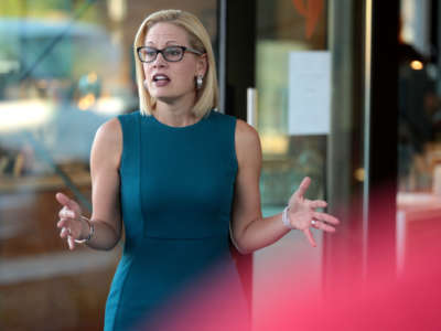 Congresswoman Kyrsten Sinema speaking with supporters at a neighborhood canvas hosted by the Arizona Education Association at Provision Coffee Arcadia in Phoenix, Arizona, on October 24, 2018.