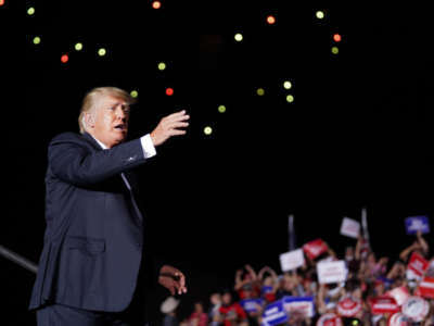 Former President Donald Trump waves to the crowd at the end of a rally on September 25, 2021, in Perry, Georgia.