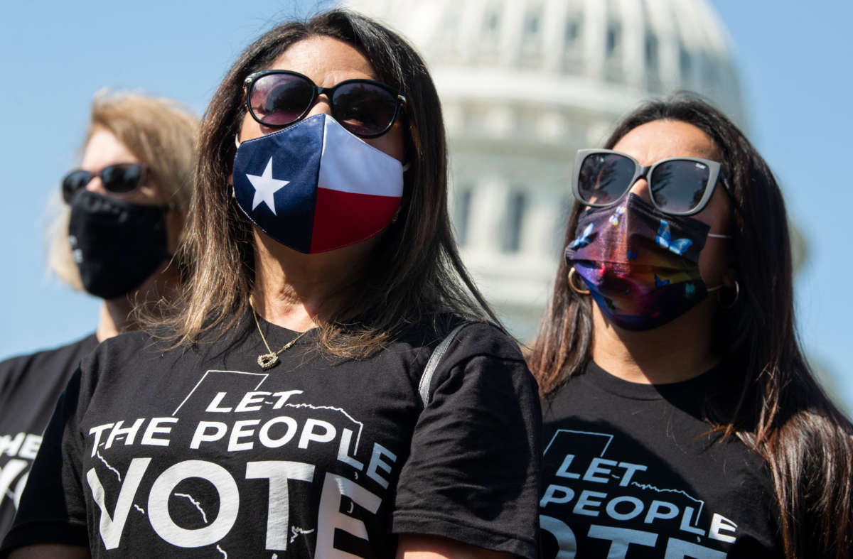 Texas State Representatives Mary Ann Perez, center, and Christina Morales, right, attend a news conference with members of the Texas House Democratic Caucus outside the U.S. Capitol on August 6, 2021.