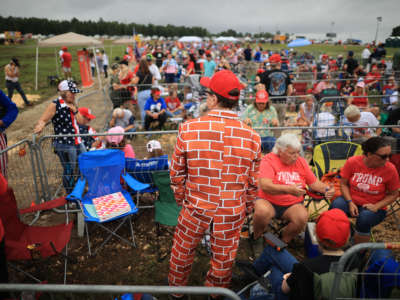 Supporters of former President Donald Trump line up to attend a "Save America" rally at York Family Farms on August 21, 2021, in Cullman, Alabama.