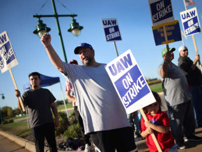 Workers picket outside of John Deere Harvester Works facility on October 14, 2021, in East Moline, Illinois.