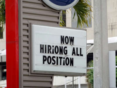 A Now Hiring sign is pictured outside of a business on October 8, 2021, in Miami, Florida.