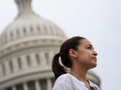 Rep. Alexandria Ocasio-Cortez talks with a reporter on the House steps of the U.S. Capitol on August 3, 2021, in Washington, D.C.