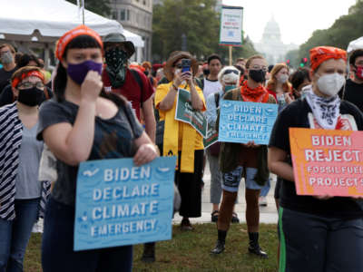 Climate activists participate in a pre-march rally at Freedom Plaza on October 15, 2021, in Washington, D.C.