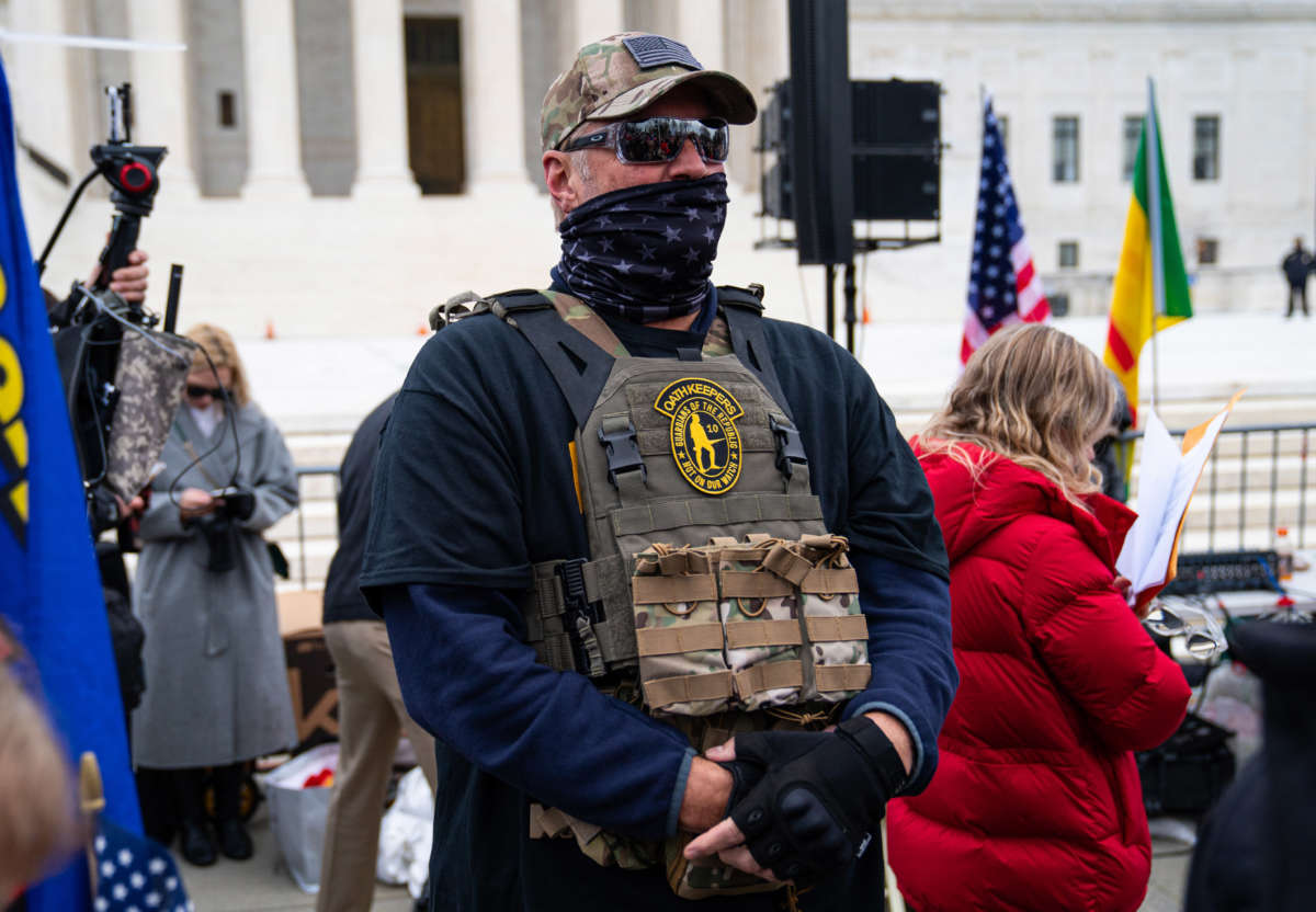 A member of the right-wing group Oath Keepers stands guard during a rally in front of the U.S. Supreme Court Building on January 5, 2021 in Washington, D.C.
