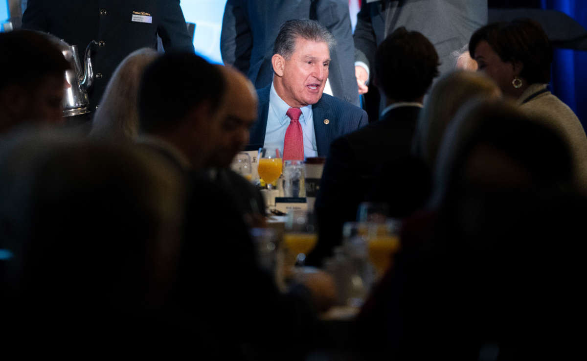 Sen. Joe Manchin mingles with guests before speaking during an event with the Economic Club of Washington at the Capitol Hilton Hotel on October 26, 2021, in Washington, D.C.