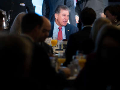 Sen. Joe Manchin mingles with guests before speaking during an event with the Economic Club of Washington at the Capitol Hilton Hotel on October 26, 2021, in Washington, D.C.