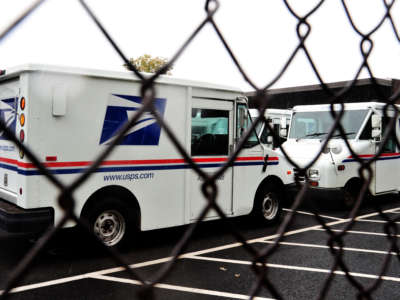 U.S. Postal Service mail delivery trucks sit idle at the Manassas Post Office in Virginia on September 5, 2011.