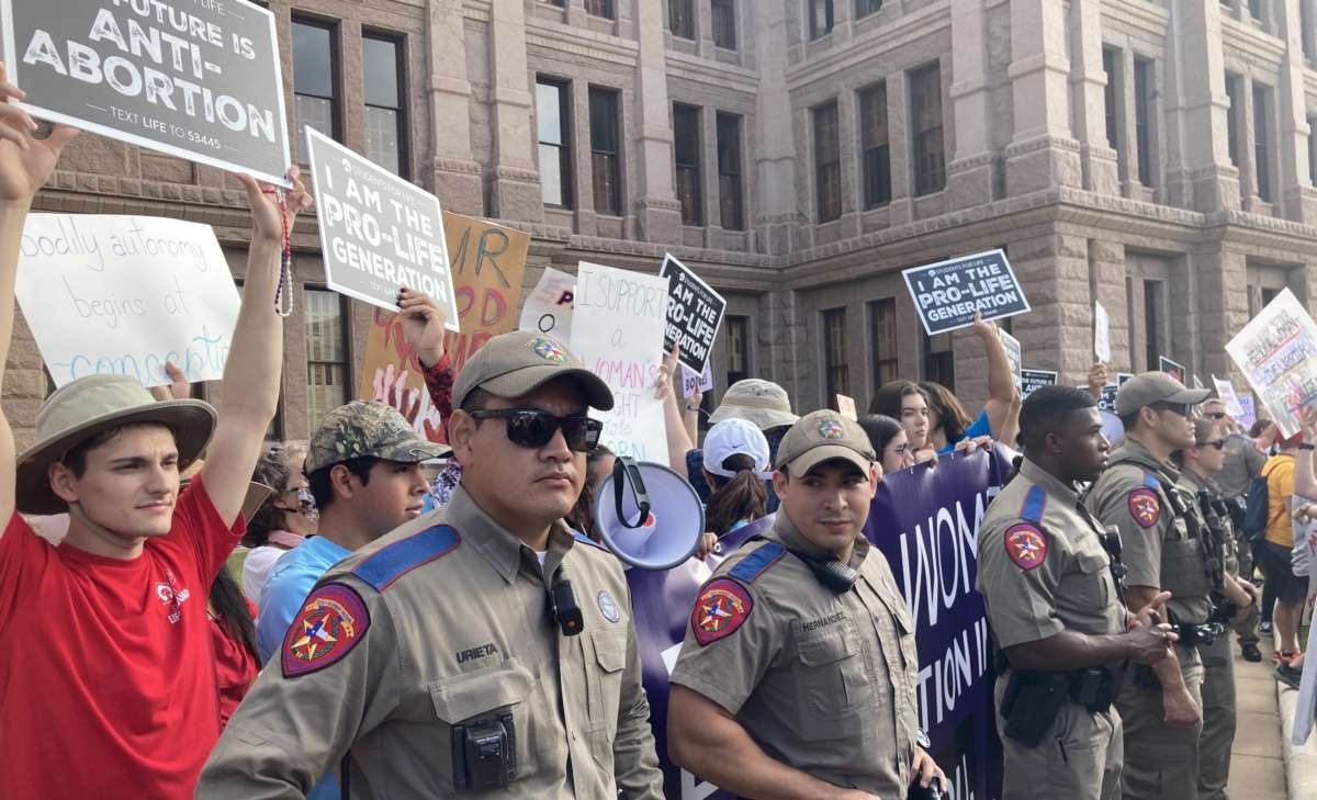 State troopers with the Texas Department of Public Safety protect a small anti-abortion counterprotest on the south lawn of the Texas State Capitol in Austin on October 2, 2021, during Women's March ATX.