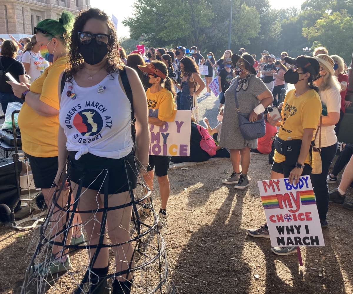 A protester wears a dress fashioned out of coat hangers on the south lawn of the Texas State Capitol in Austin, Texas, on October 2, 2021 during Women's March ATX.