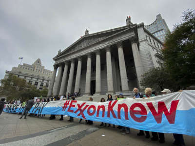 People take part in a protest against ExxonMobil before the start of its trial outside the New York State Supreme Court building on October 22, 2019, in New York, USA.