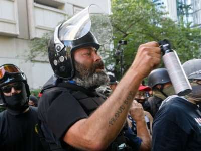 Alan Swinney, a "Proud Boy" member, pepper-sprays counter-demonstrators as right-wing demonstrators, many armed, clash violently with Black Lives Matter and antifascist counter-demonstrators, in Portland, Oregon, on August 22, 2020.