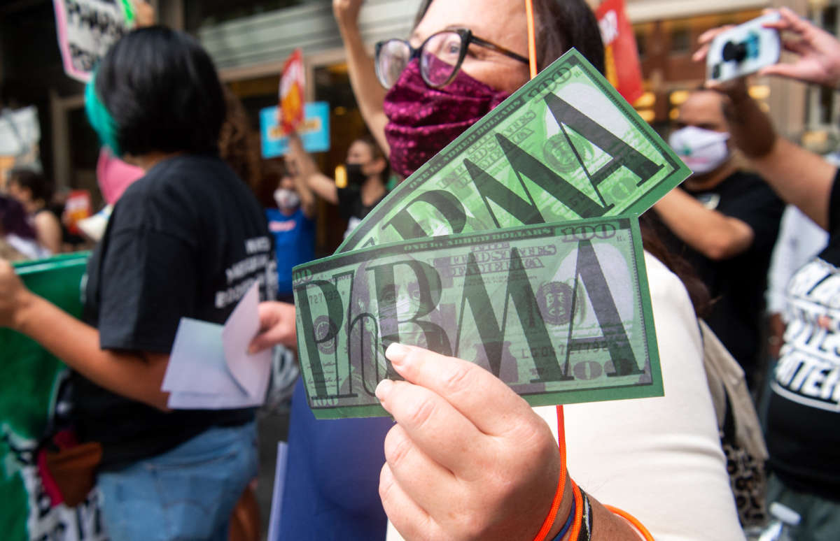 Demonstrators from the People's Action protest pharmaceutical companies' lobbying against allowing Medicare to negotiate lower prescription drug prices, during a rally outside Pharmaceutical Research and Manufacturers of America (PhRMA) headquarters in Washington, D.C., on September 21, 2021.
