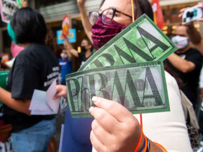 Demonstrators from the People's Action protest pharmaceutical companies' lobbying against allowing Medicare to negotiate lower prescription drug prices, during a rally outside Pharmaceutical Research and Manufacturers of America (PhRMA) headquarters in Washington, D.C., on September 21, 2021.