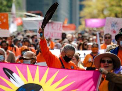 People participate in the "Every Child Matters" march to mark the first National Day for Truth and Reconciliation in Montréal, Canada, on September 30, 2021. The mobilization is part of the "Every Child Matters" movement to commemorate the victims of Residential Schools, the last of which closed in 1996 in Canada.