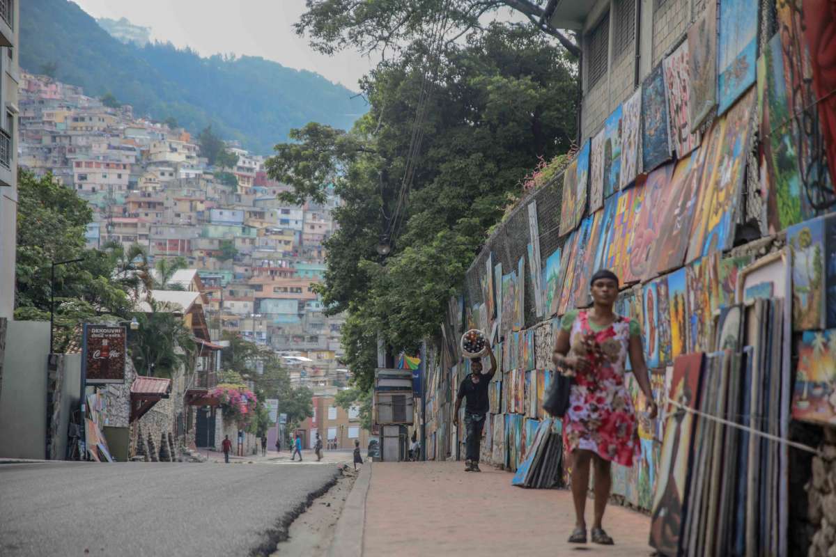 A couple of people walk in the deserted street in Port-au-Prince, Haiti, on October 18, 2021.