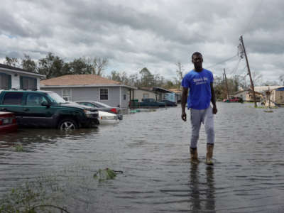 A resident of Laplace, Louisiana, wades through floodwaters after Hurricane Ida made landfall August 29, 2021, as a category 4 storm southwest of New Orleans. Water has always shaped life in Louisiana, where people are already preparing for intensifying storms and demanding the next generation of climate resilient green infrastructure.