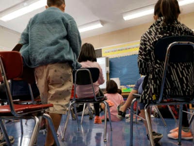 Masked students participate in a lesson in their classroom at Yung Wing School P.S. 124 on September 27, 2021, in New York City.