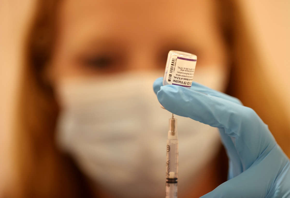 Safeway pharmacist Ashley McGee fills a syringe with the Pfizer COVID-19 booster vaccination at a vaccination booster shot clinic on October 1, 2021, in San Rafael, California.