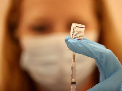 Safeway pharmacist Ashley McGee fills a syringe with the Pfizer COVID-19 booster vaccination at a vaccination booster shot clinic on October 1, 2021, in San Rafael, California.