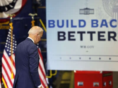 President Joe Biden prepares to walk off a stage after giving a speech on his Bipartisan Infrastructure Deal and Build Back Better Agenda at the NJ Transit Meadowlands Maintenance Complex on October 25, 2021, in Kearny, New Jersey.