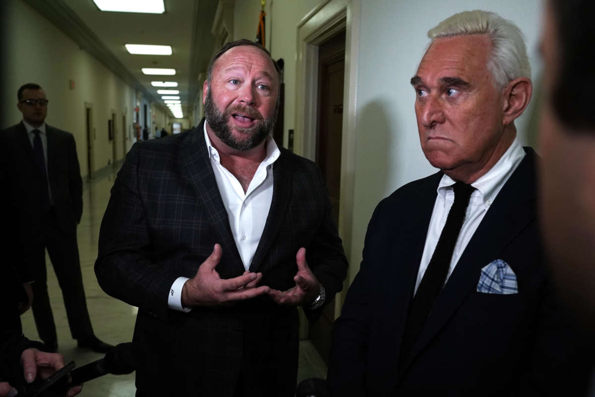 Longtime informal adviser to President Trump Roger Stone, right, and Alex Jones of Infowars speak to cameras outside a hearing at the Rayburn House Office Building on December 11, 2018, in Washington, D.C.