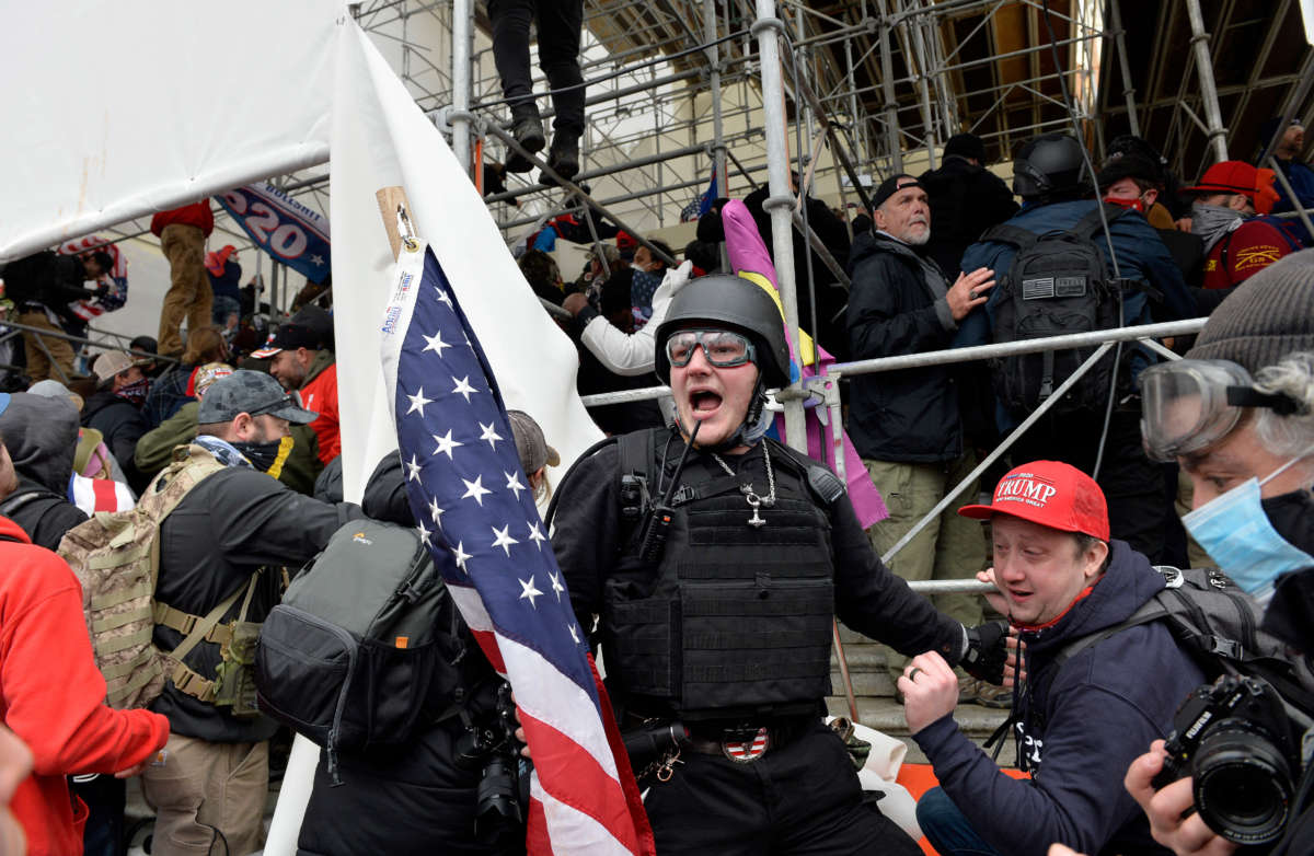 A man calls on people to raid the building as Trump supporters clash with police and security forces as they try to storm the U.S. Capitol in Washington, D.C., on January 6, 2021.