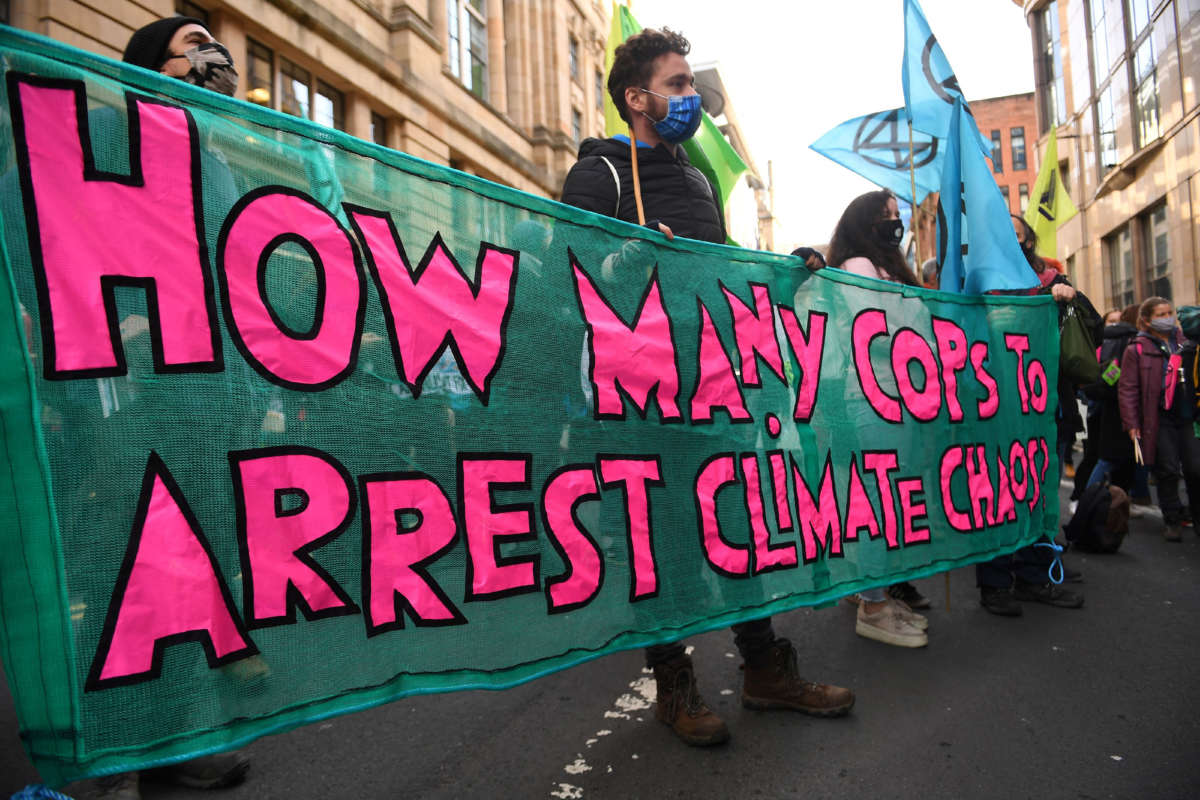 Climate activists from the Extinction Rebellion group demonstrate outside the offices of JP Morgan in Glasgow, during the COP26 UN Climate Change Conference, on November 2, 2021.