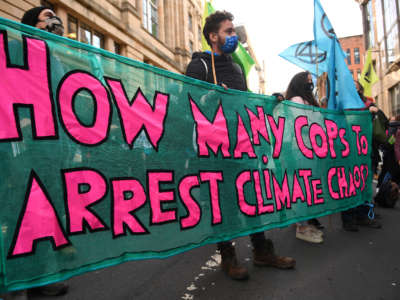 Climate activists from the Extinction Rebellion group demonstrate outside the offices of JP Morgan in Glasgow, during the COP26 UN Climate Change Conference, on November 2, 2021.