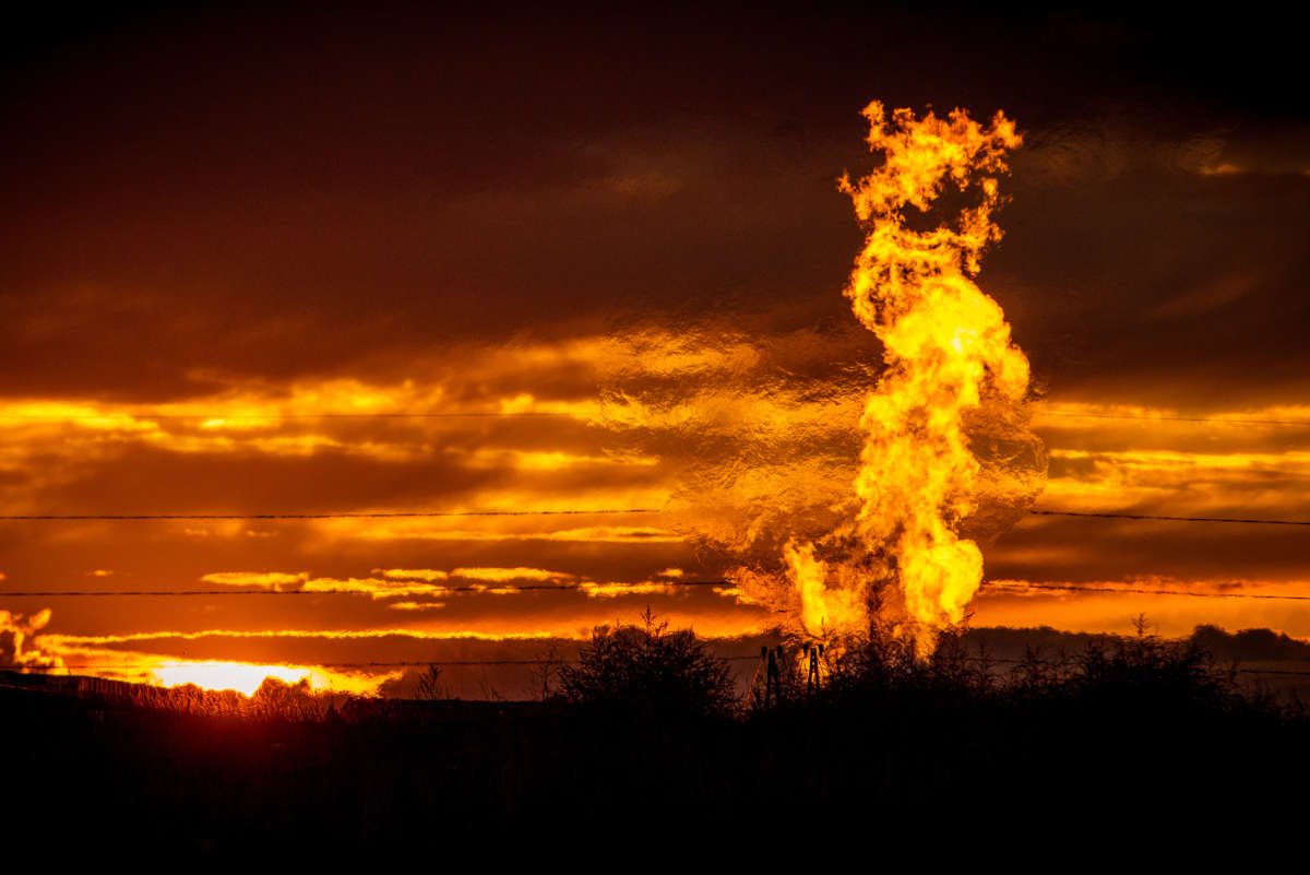 Flames rise from a flaring pit near a well in the Bakken Oil Field, pictured on October 1, 2014.