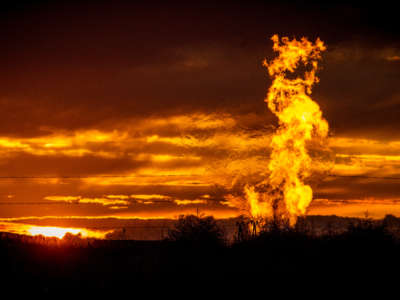 Flames rise from a flaring pit near a well in the Bakken Oil Field, pictured on October 1, 2014.