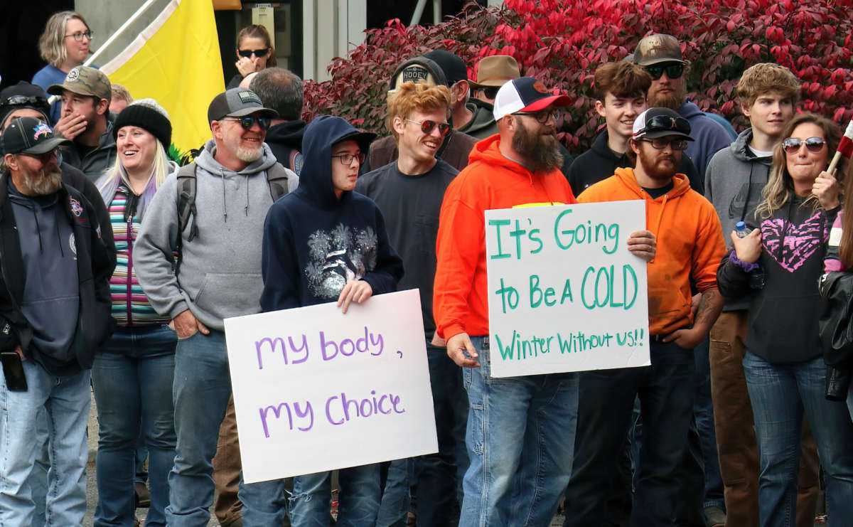 A crowd of protesters against COVID-19 vaccine mandates stands outside the headquarters of City Light, Seattle's public utility, on October 18, 2021.