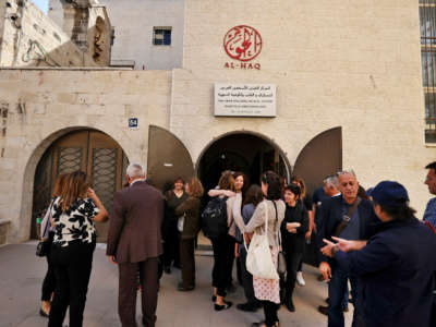 Israeli left-wing activists gather with Palestinian activists at the Al-Haq Foundation in the West Bank city of Ramallah to denounce Israel's decision to declare six Palestinian human rights groups as "terror organizations," on October 27, 2021.