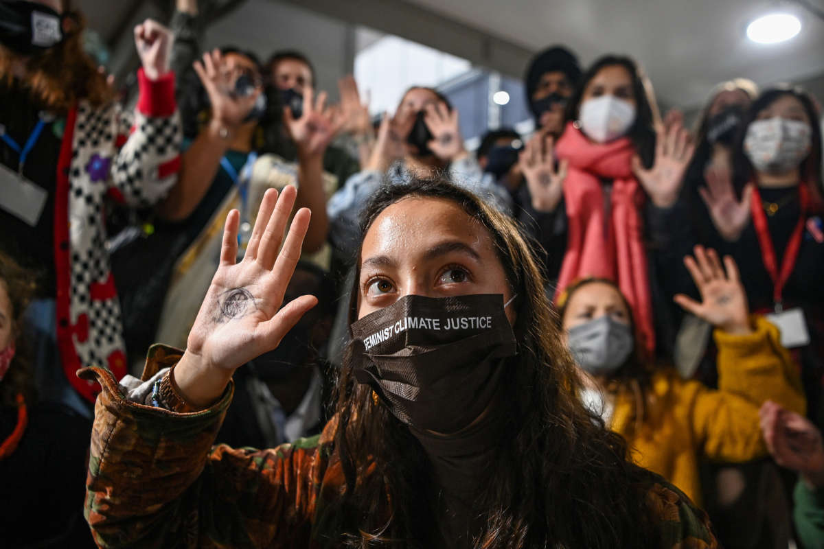 Youth Climate Activists protest against fossil fuels outside the plenary rooms at COP26 as high-level negotiations continue among world governments on November 10, 2021, in Glasgow, Scotland.