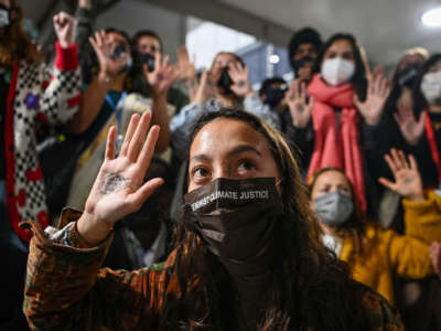 Youth Climate Activists protest against fossil fuels outside the plenary rooms at COP26 as high-level negotiations continue among world governments on November 10, 2021, in Glasgow, Scotland.