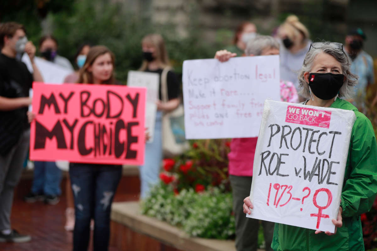 A woman holds a placard referring to Roe v Wade as demonstrators gather at the Sample Gates at Indiana University to rally in support of reproductive rights, in Bloomington, Indiana, on October 2, 2021.