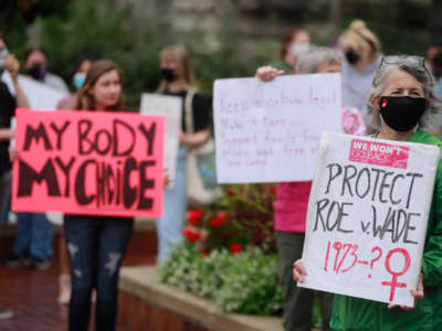 A woman holds a placard referring to Roe v Wade as demonstrators gather at the Sample Gates at Indiana University to rally in support of reproductive rights, in Bloomington, Indiana, on October 2, 2021.