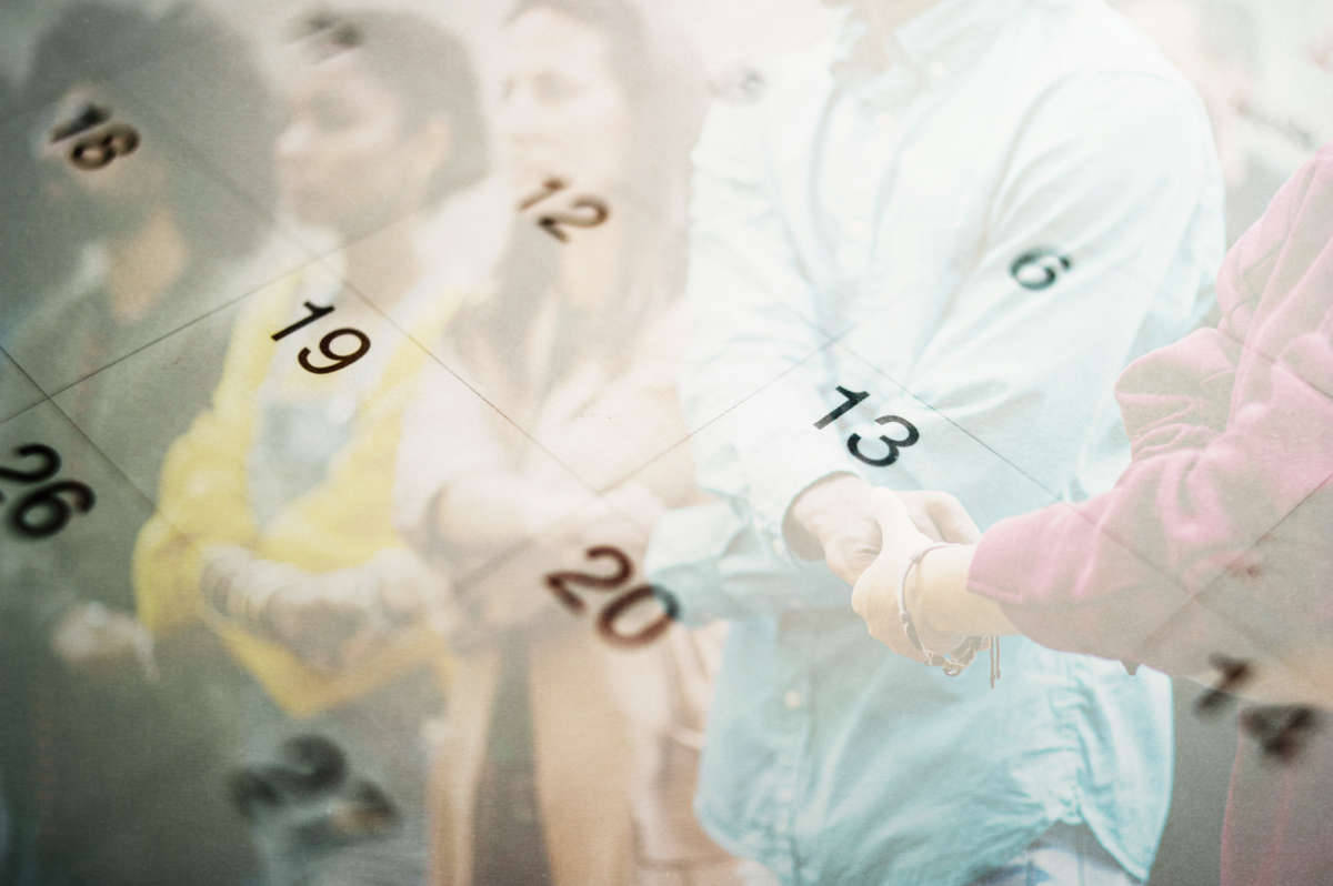 People holding hands at protest with calendar grid overlay