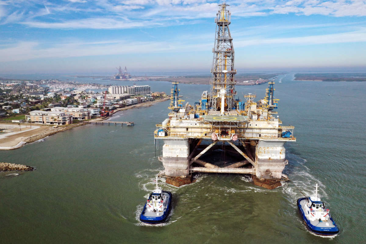 Tug boats tow the semi-submersible drilling platform Noble Danny Adkins through the Port Aransas Channel into the Gulf of Mexico on December 12, 2020, in Port Aransas, Texas.